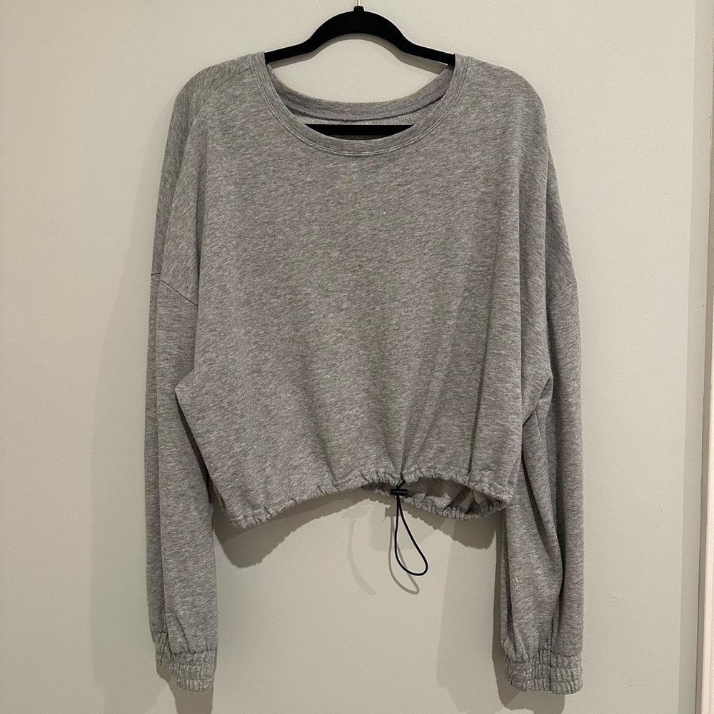 Grey pullover cinched at bottom